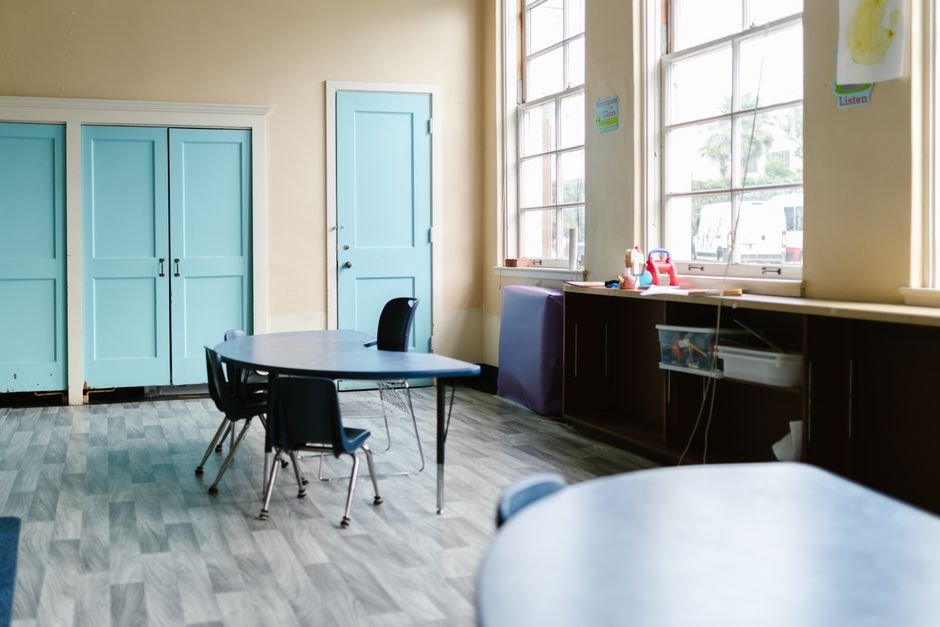 Single classroom desk by a window with afternoon light pouring in, the formal-classroom register this nickel boys review weighs against the camera's larger discipline