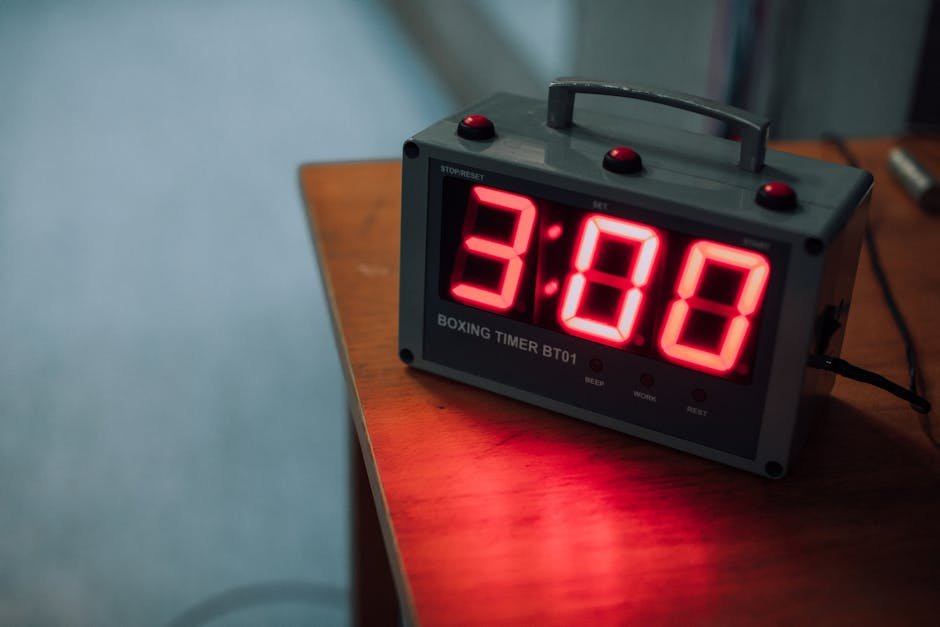 Stopwatch resting on a sheet of timecode notes beside a film strip, the literal measurement of how movie editing changes pacing in a working room