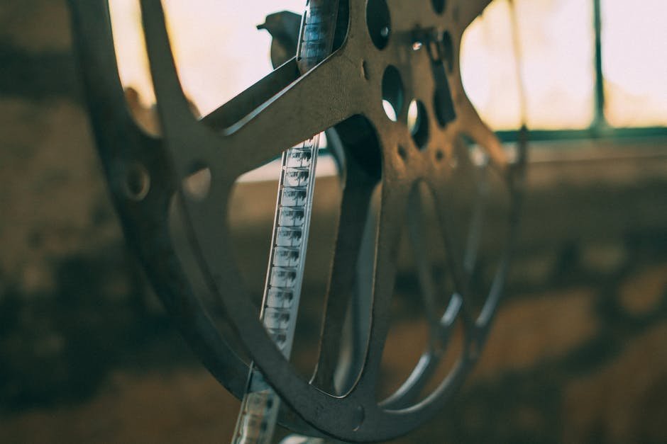 Single film reel beside a notebook of handwritten timing notes, the kind of close attention the best slow burn movies have always rewarded from their audiences