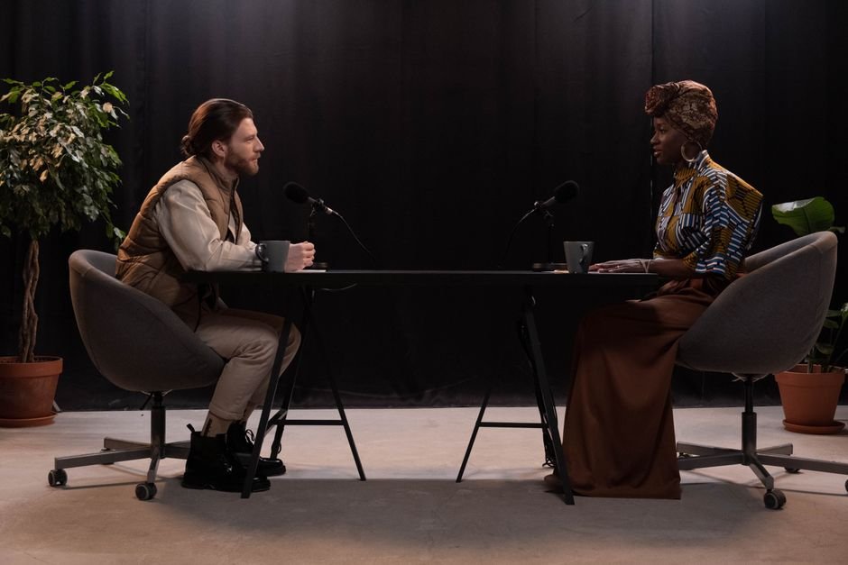 Two empty chairs facing each other across a table under low light evoking the best dialogue driven movies