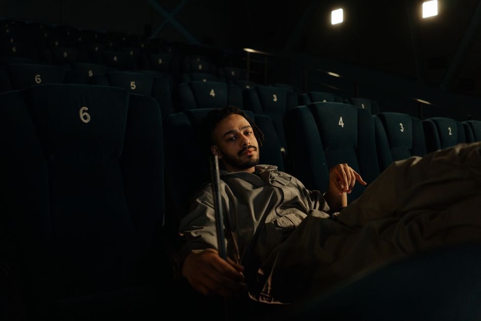 An empty cinema auditorium lit only by the screen glow, a conceptual image for the best psychological thriller movies